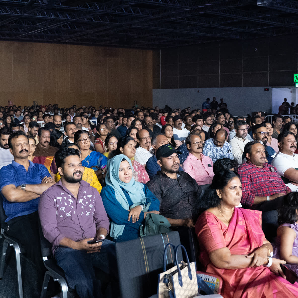 A packed auditorium of members watching the annual programme