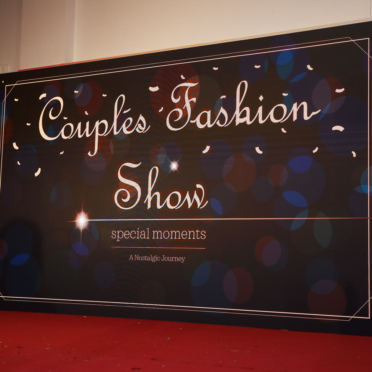The Couples Fashion Show backdrop on stage before the item begins