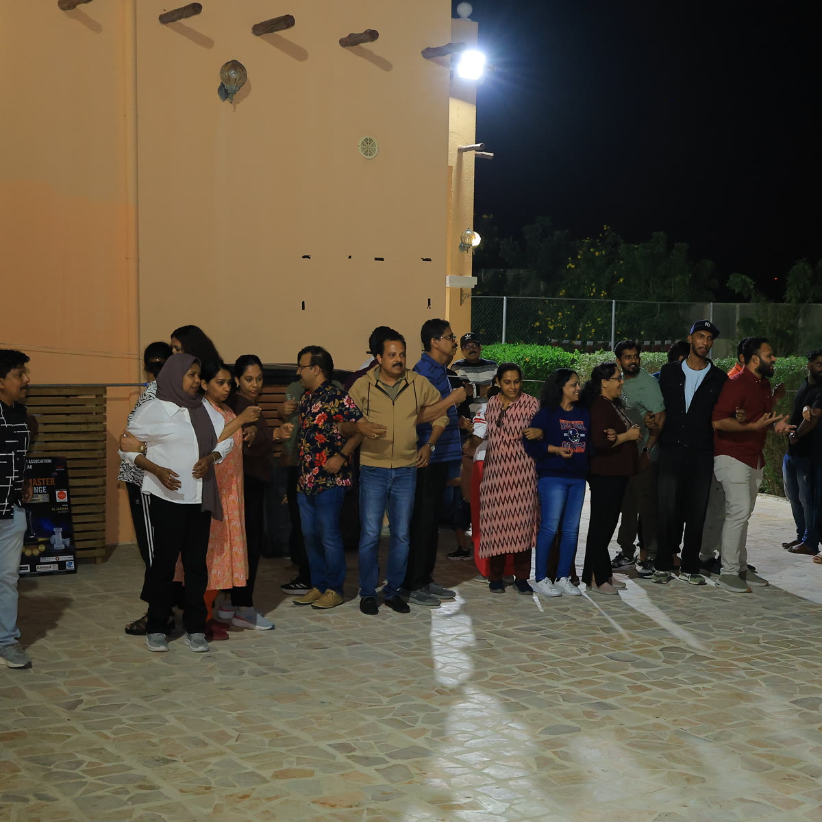 Members gathered outdoors on a warm evening