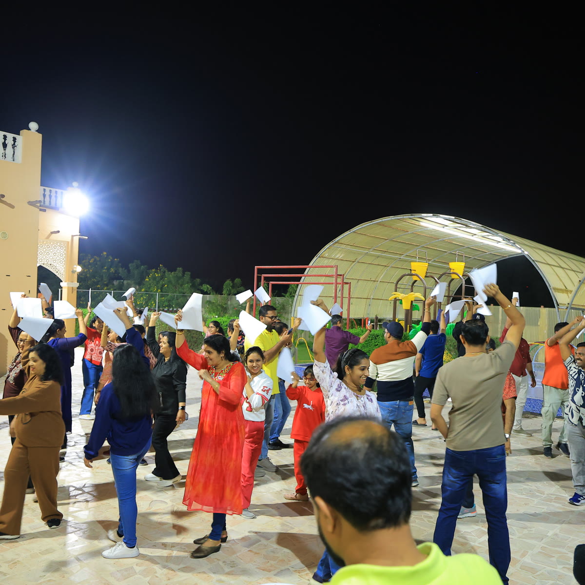 Members gathered under marquees at an outdoor evening event