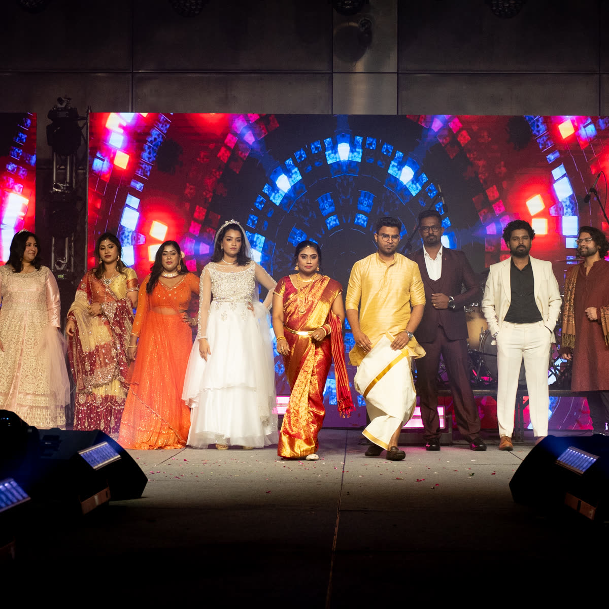 Members walking the stage together during the couples fashion show