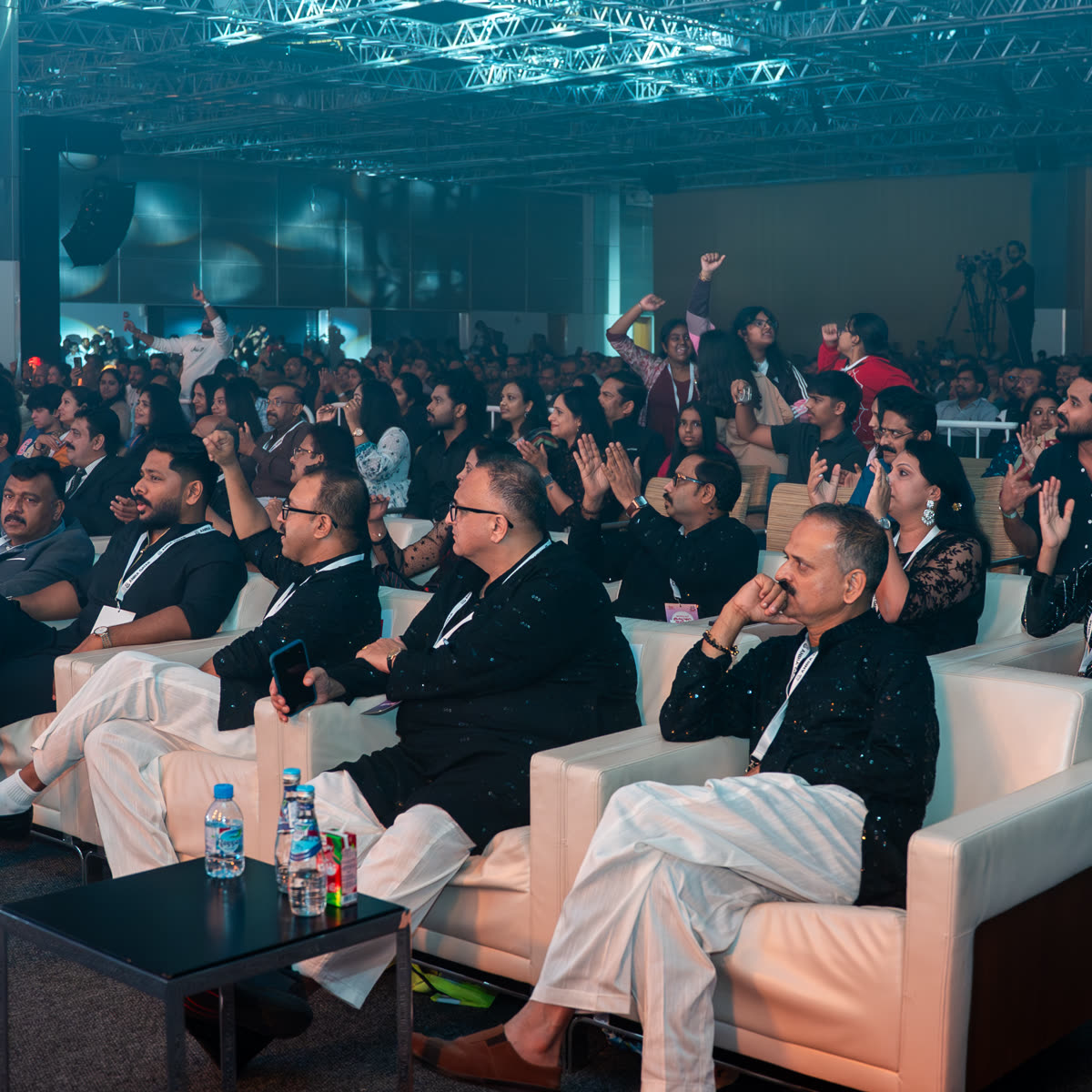 Invited guests seated in the front row watching the programme