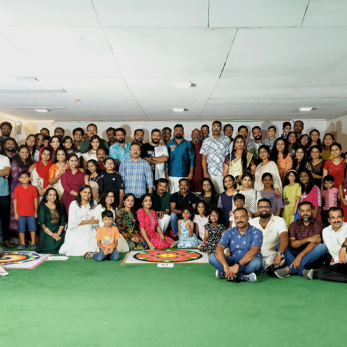 A large group of ANRIA Qatar members and their families gathered outdoors for a group photograph