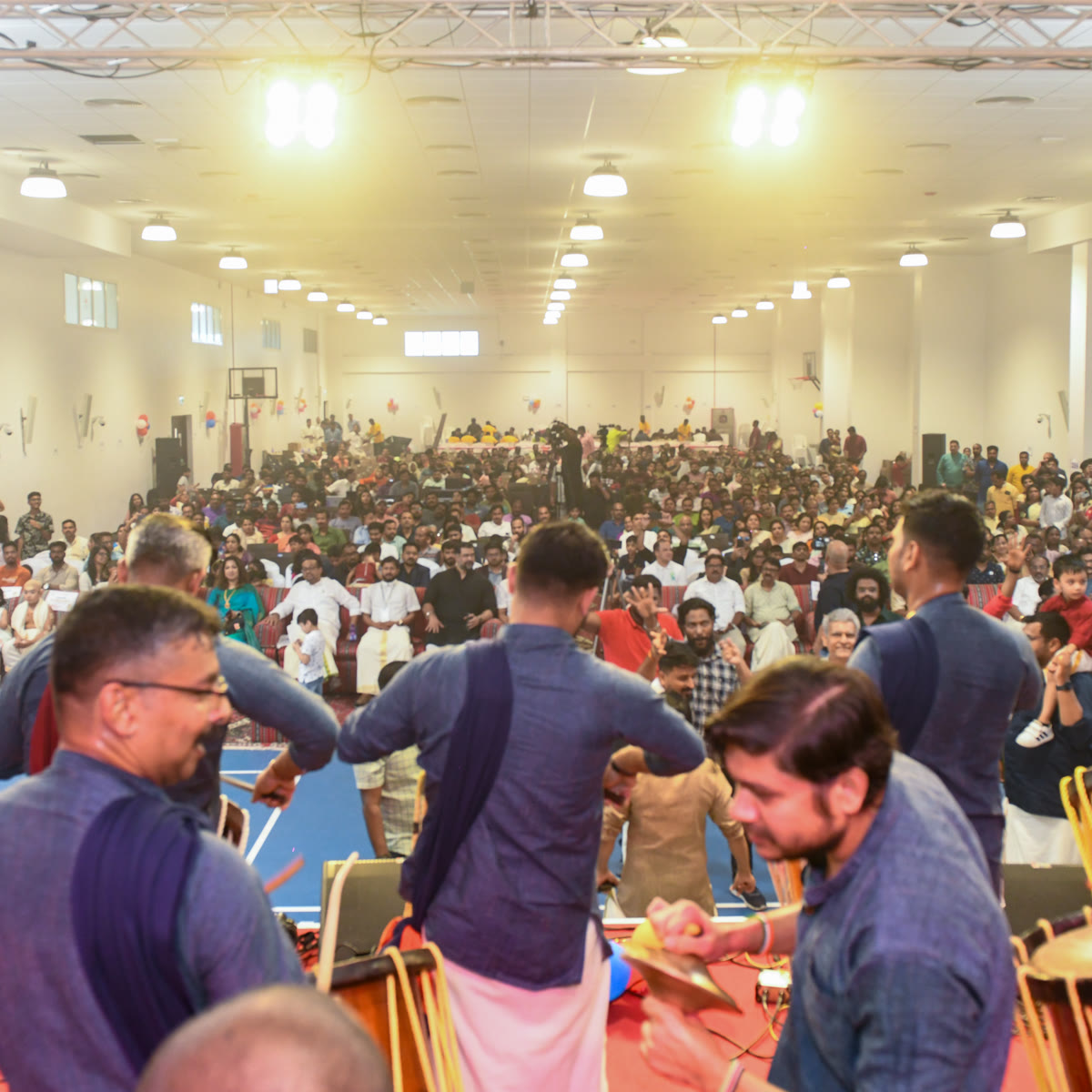 A full hall of members watching the Onam stage programme