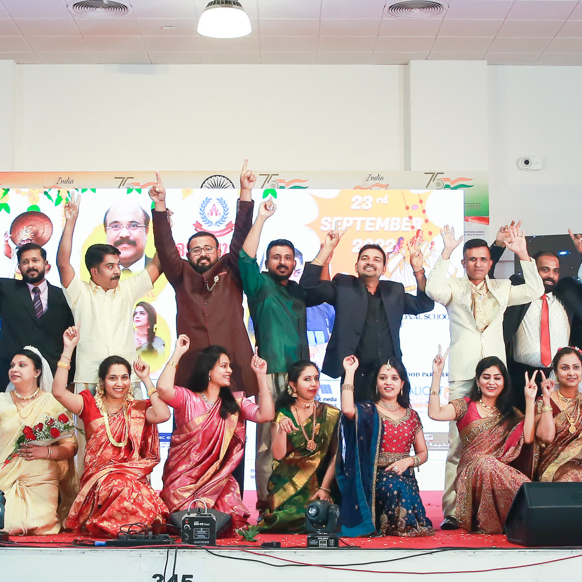 Members and families assembled for a group photograph at the Onam celebration