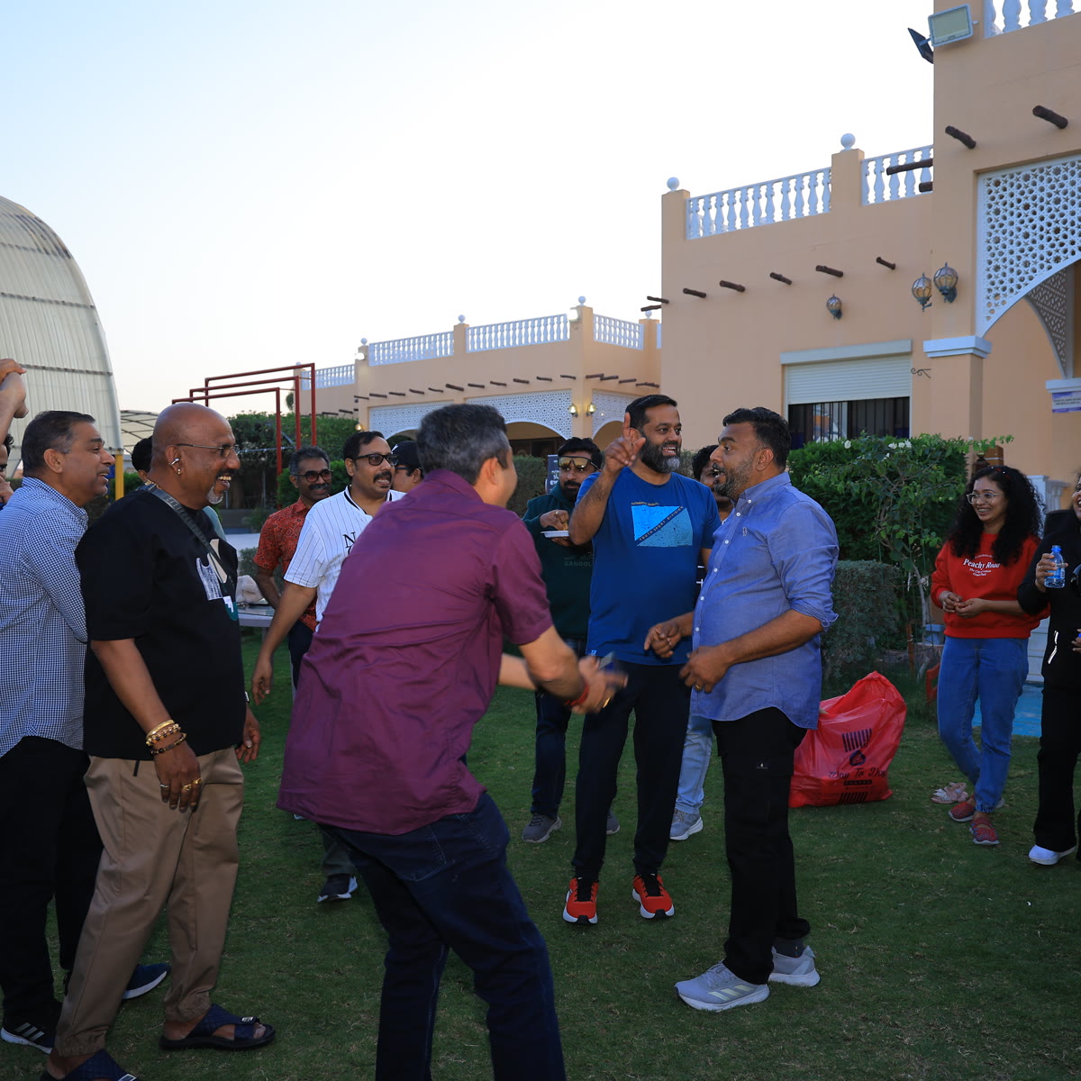 Families gathered on a lawn during a daytime outdoor event