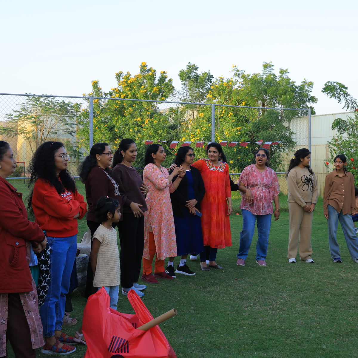 Members standing together on a lawn at an outdoor gathering