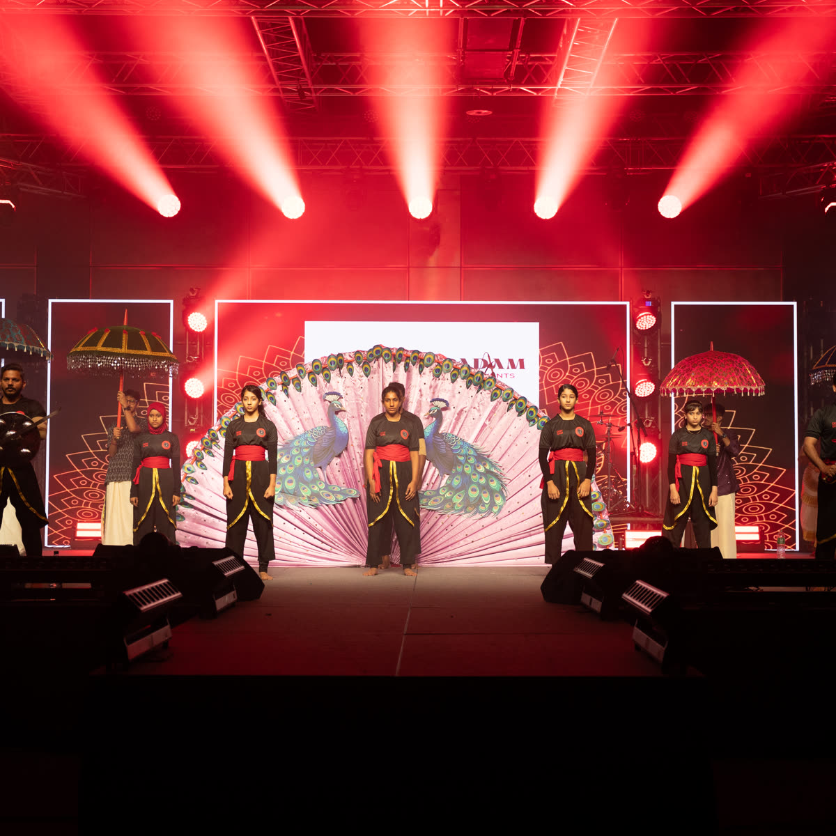 A decorated stage lit in red for the opening of the cultural programme